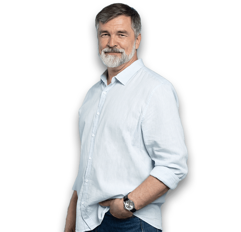Middle aged Austin man standing with his hand in his pocket.