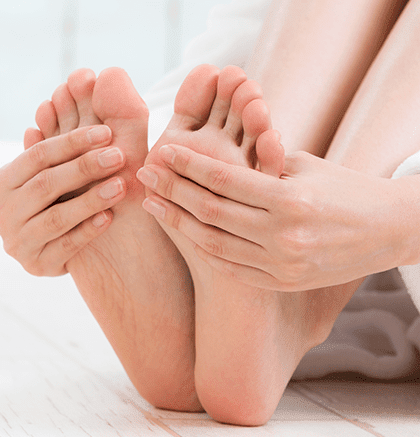 Dermatologist examining patient’s toenails for nail fungus