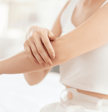 Dermatologist examining patient’s skin for dryness and irritation
