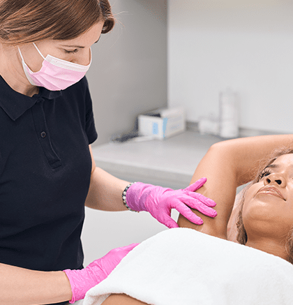 Dermatologist examining underarm area for hidradenitis suppurativa